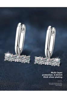 Macro shot of 925 silver U-shape earrings with inlaid cubic zirconia and nano-plating