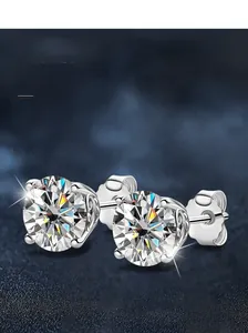 Detailed view of 925 sterling silver four-prong stud earrings with sparkling round moissanite