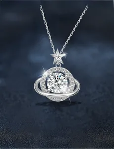 Macro shot of 925 sterling silver planet necklace with moissanite and star detail