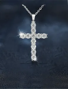 Macro detail of 925 silver cross pendant with 3EX cut moissanite stones and brilliant fire
