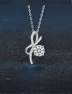 Macro shot of 925 silver bow pendant showing 3EX hearts and arrows cut moissanite detail