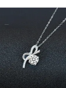 Detailed view of S925 sterling silver bow pendant with shimmering moissanite gemstone