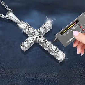 Moissanite 925 silver cross pendant necklace being tested with a professional diamond tester