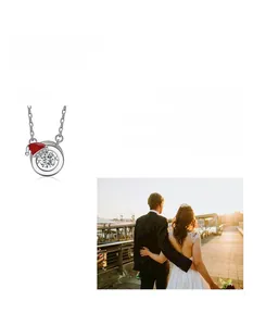 Detail of 925 silver moissanite necklace featuring a festive mini Christmas hat charm