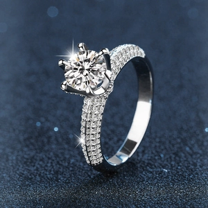 Moissanite 925 silver ring featuring a six-prong round cut diamond and pave side stones