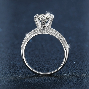 Elegant 925 sterling silver moissanite ring with six-prong crown setting on blue background