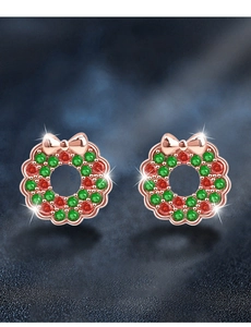Macro detail of 925 silver Christmas wreath earrings with red and green cubic zirconia