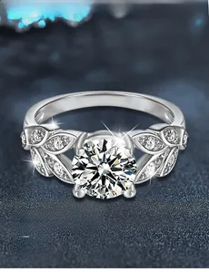 Detail of 925 silver leaf ring showing the 3EX brilliant cut moissanite and side stones