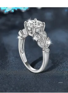 Close-up of 925 sterling silver leaf ring with moissanite in classic 4-prong setting