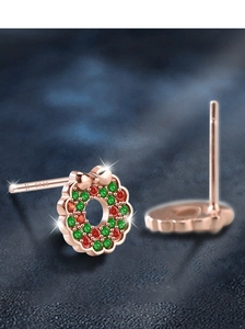 Macro view of S925 silver Christmas wreath studs with red and green zircon pavé