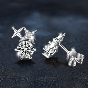Sparkling 925 sterling silver star stud earrings with round moissanite in a macro shot