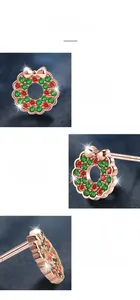 Detail of S925 sterling silver stamp and red green gemstone Christmas wreath earrings