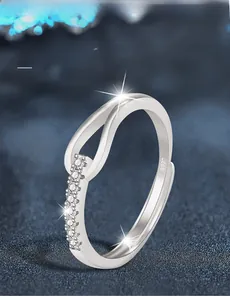 Detail of S925 sterling silver ring featuring a crisscross band with pavé moissanite stones