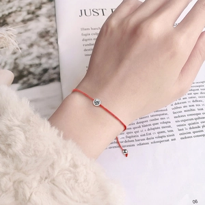 Minimalist red woven moissanite 925 sterling silver bracelet worn on a female wrist