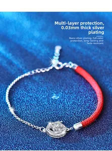Macro detail of red cord bracelet with silver plated dragon motif and moissanite stone