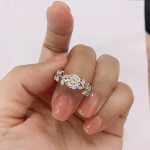 Elegant S925 sterling silver ring featuring a round moissanite and leaf diamond design