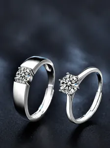 Macro shot of S925 sterling silver couple rings with brilliant six-claw moissanite stones