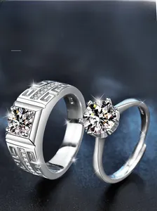Macro detail of S925 sterling silver couple rings featuring Greek pattern and moissanite stone