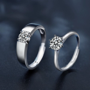Adjustable 925 sterling silver couple rings with moissanite stones on navy background