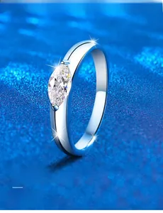 Macro side view of marquise-cut moissanite ring with polished silver 3EX sparkle detail
