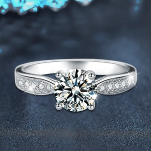 Elegant s925 silver four-prong moissanite ring with side stones on a blue background