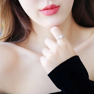 Classic S925 sterling silver four-prong moissanite ring worn on a female model's finger
