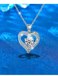 Macro shot of S925 silver heart necklace with blue stones and engraved love message