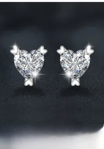 Close-up of heart-cut moissanite stud earrings in S925 sterling silver three-prong setting