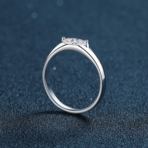 Elegant S925 sterling silver ring with a marquise cut moissanite on a dark blue background