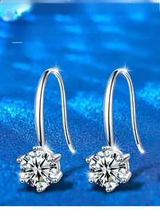 Detail of 925 silver six-prong moissanite earrings with 3EX round cut on blue background