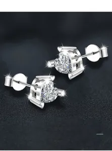 Macro view of heart-cut moissanite stud earrings with polished silver plating finish