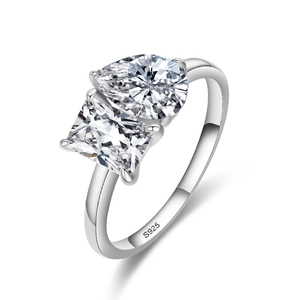 925 sterling silver ring with pear and princess cut moissanite stones on white background