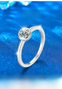 Macro shot of S925 sterling silver ring with a round moissanite in a bezel bubble setting