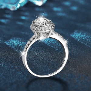 Elegant 925 sterling silver moissanite ring with large round halo stone on blue background