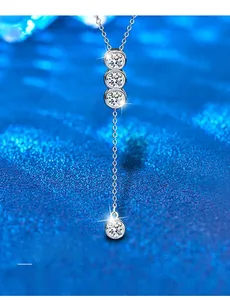 Macro detail of Y-shaped silver necklace with 3EX cut moissanite pendant and tassels