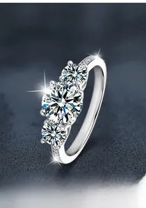 Macro shot of 925 silver three-stone moissanite ring with brilliant side diamonds