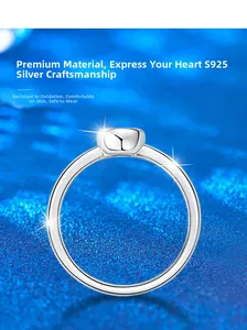 Close-up of a polished S925 sterling silver ring on a sparkling blue textured background