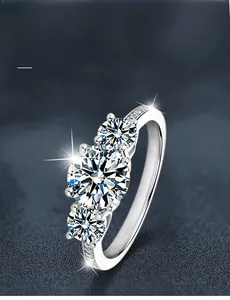 Macro detail of three-stone 925 silver ring featuring round brilliant cut moissanite stones