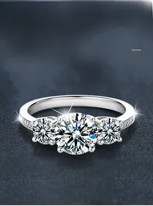 Detail view of three-stone 925 silver ring with multi-layer plating and side diamonds