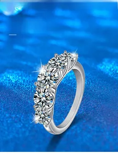 Detailed close-up of 925 sterling silver ring featuring five 3EX cut moissanite stones