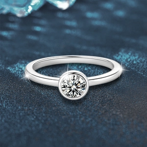 Classic 925 sterling silver ring with a round bezel-set moissanite on blue background