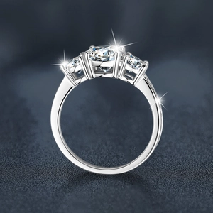 Three-stone 925 sterling silver ring with pavé-set side diamonds on a matte background