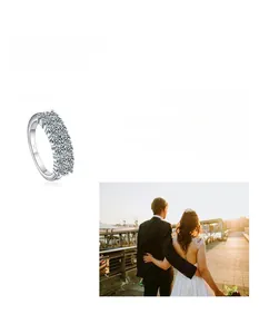 Detail of 925 silver ring with moissanite diamonds and romantic couple backdrop