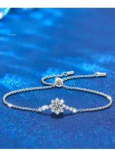 Macro shot of 925 sterling silver snowflake bracelet with 3EX cut moissanite stone