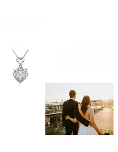 Detail of 925 sterling silver heart-shaped Moissanite necklace with wedding scene