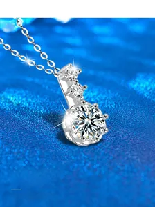 Vue macro d'un pendentif en argent S925 montrant le sertissage de trois pierres fines
