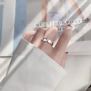Elegant 925 sterling silver moissanite ring with minimalist stud pattern on a model hand