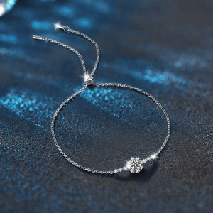 Elegant 925 sterling silver snowflake bracelet with sparkling moissanite on starry background