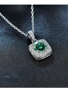 Macro shot of 925 silver necklace with square emerald green gemstone and O-chain