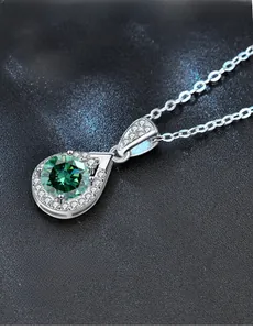 Close-up of teardrop green moissanite pendant with 3EX cut silver necklace detail